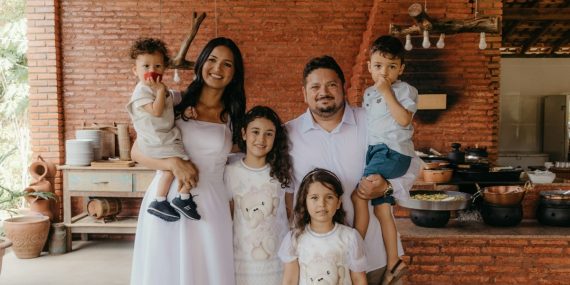a family posing for a picture in a kitchen