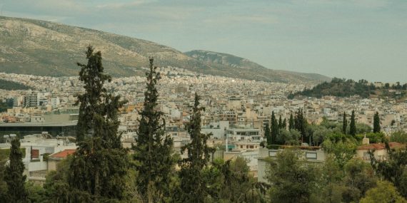 a view of a city with mountains in the background
